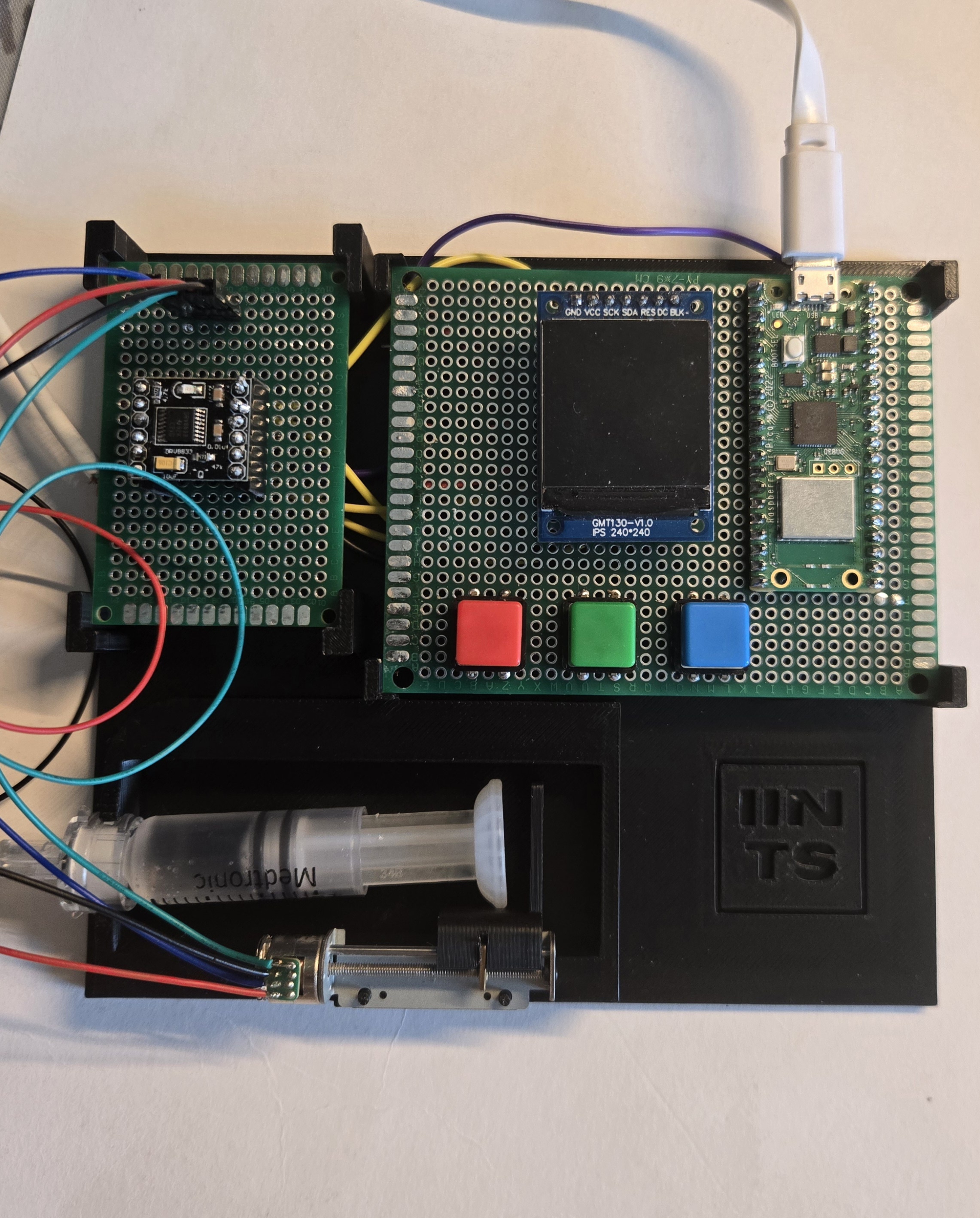 Close-up of the IINTS insulin pump prototype hardware showing RP2040 and OLED
